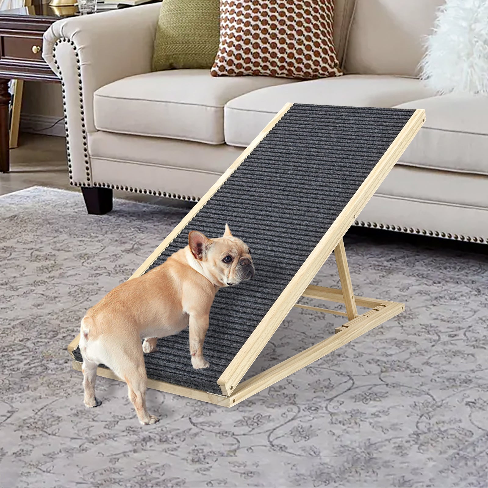Small dog using a wooden pet ramp on a carpeted floor with a couch in the background