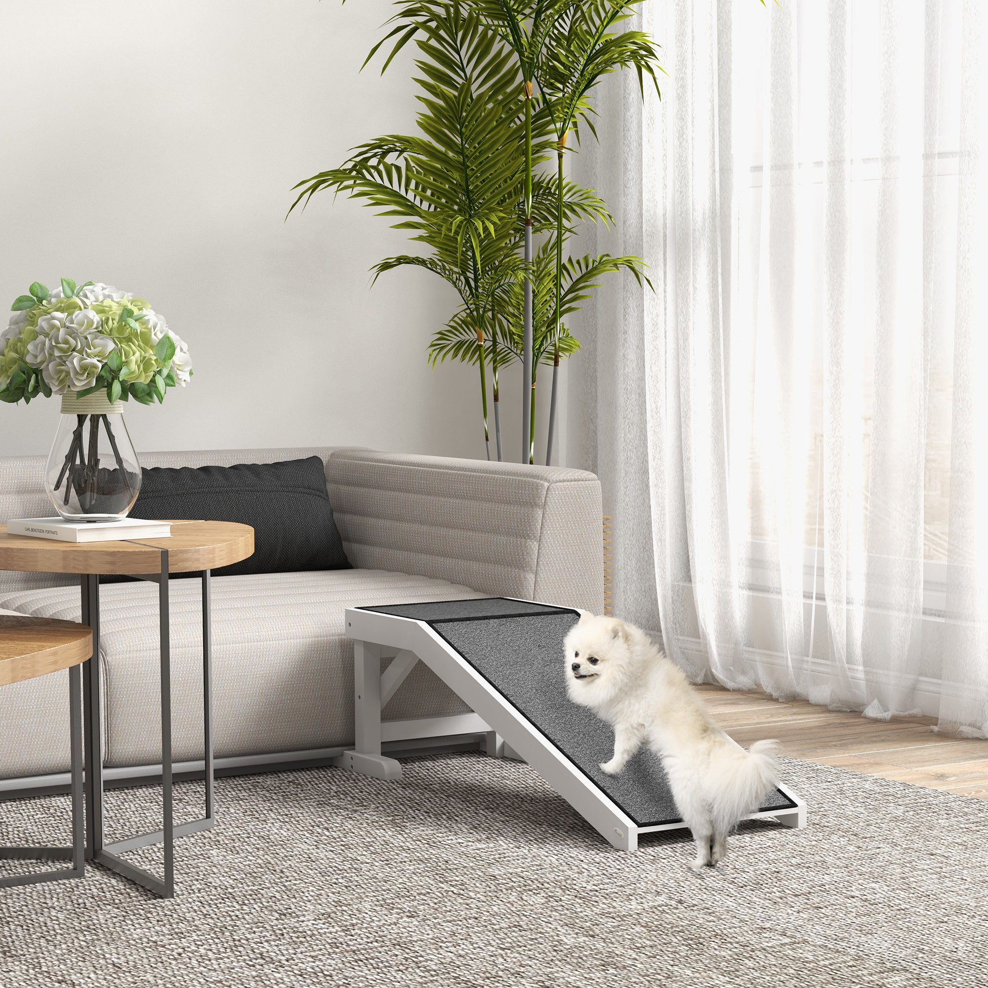 Dog using a pet ramp set against couch in a living room 