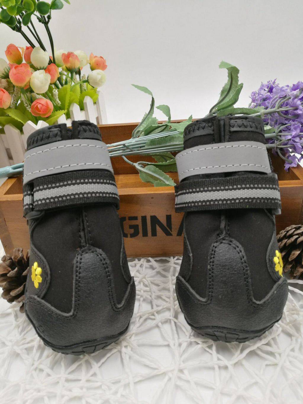 Pair of black and gray pet boots with yellow accents
