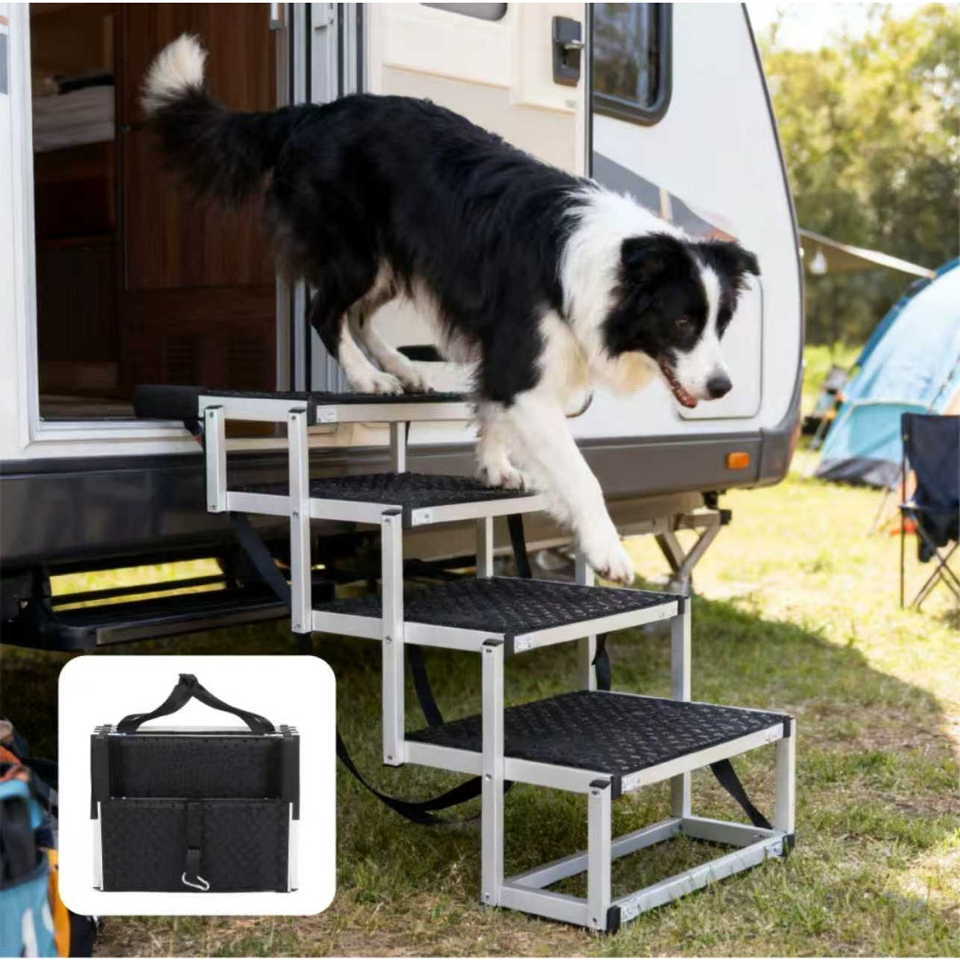 Dog using a set of pet steps to enter an RV with a carrying case inset.