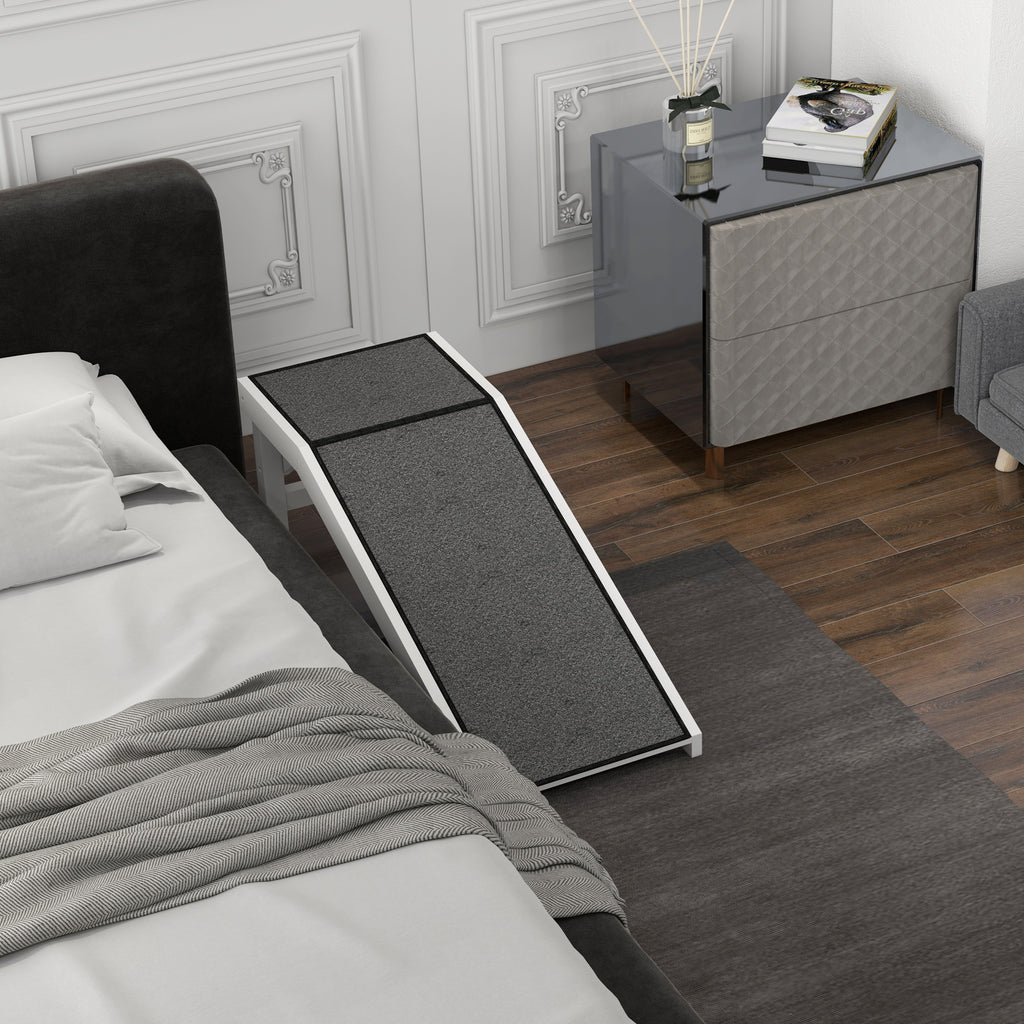 Gray pet ramp leading from a bed in bedroom