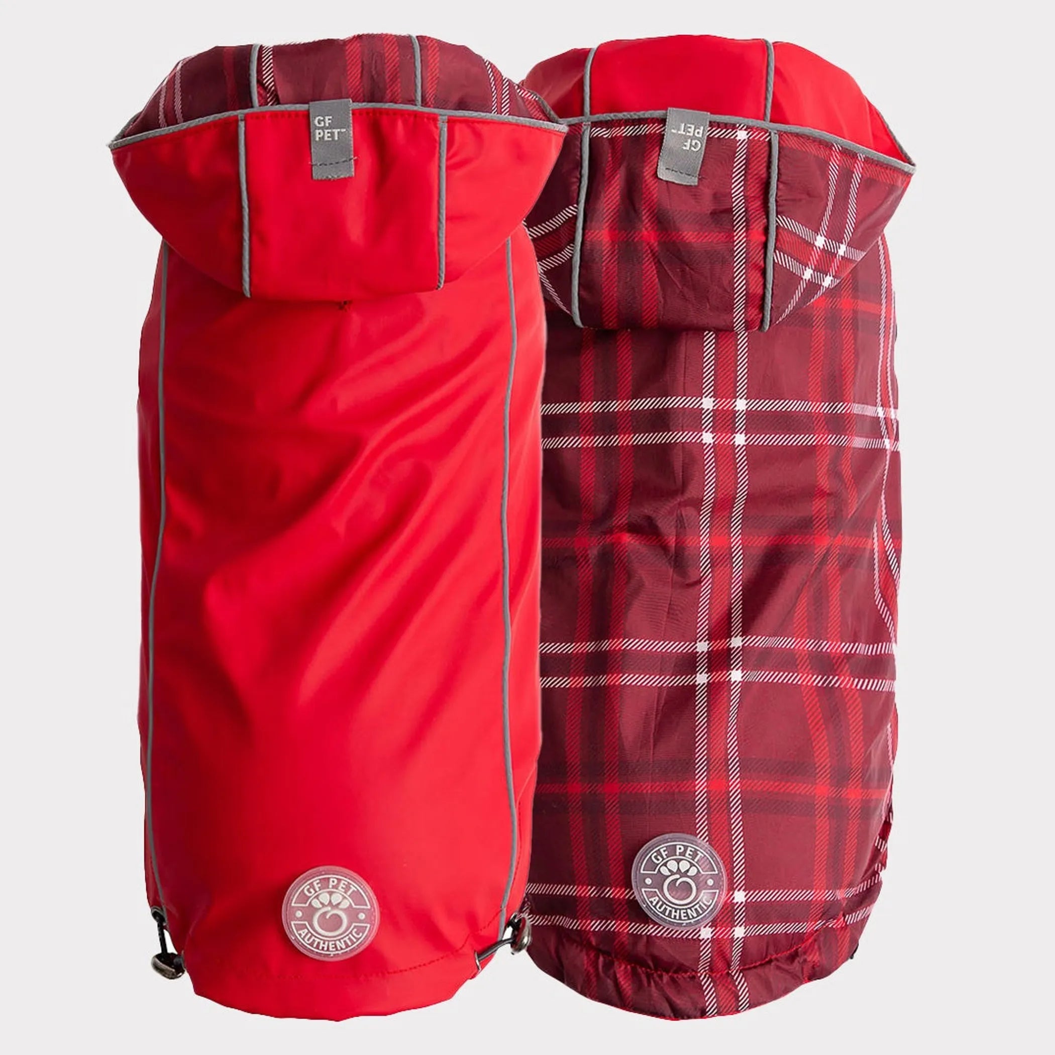 Two dog raincoats, one solid red and one red plaid 
