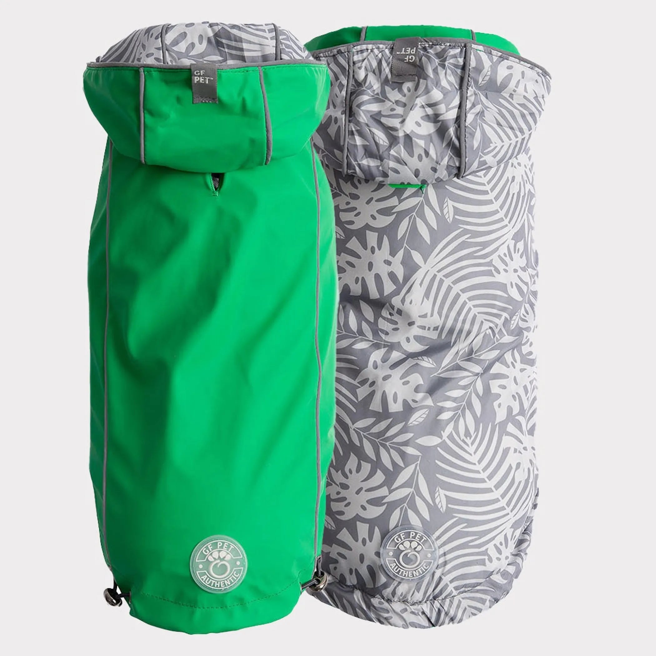 Two dog raincoats, one green and one with a grey leaf pattern