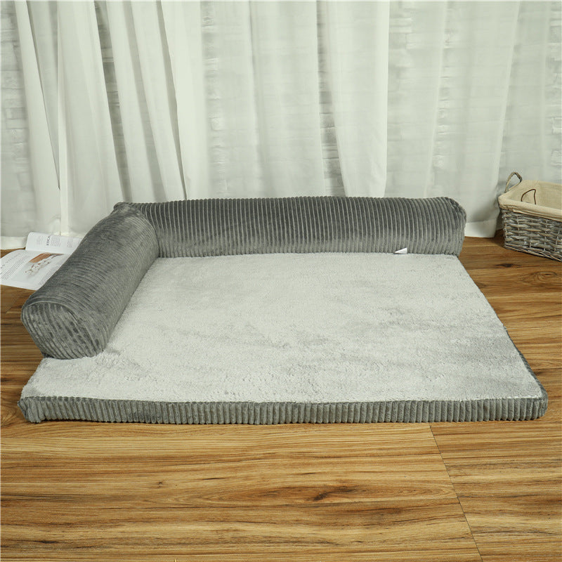 Gray corduroy pet bed on a wooden floor with cushions on two sides
