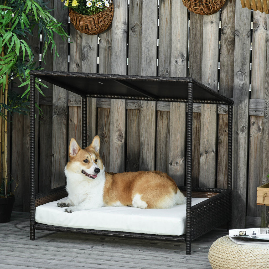 Dog lying on a black outdoor rattan pet bed 