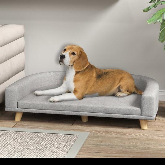 dog laying on grey pet sofa bed in living room setting